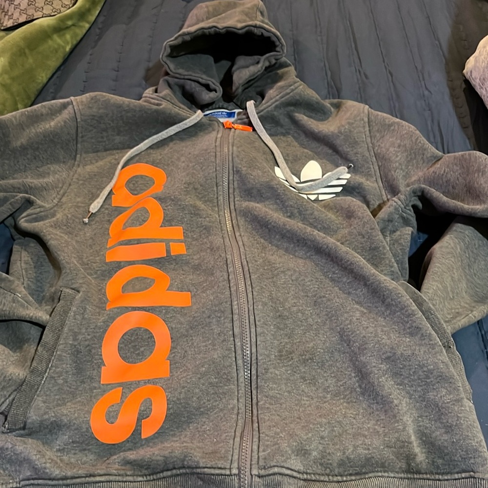Grey colored adidas hoodie.